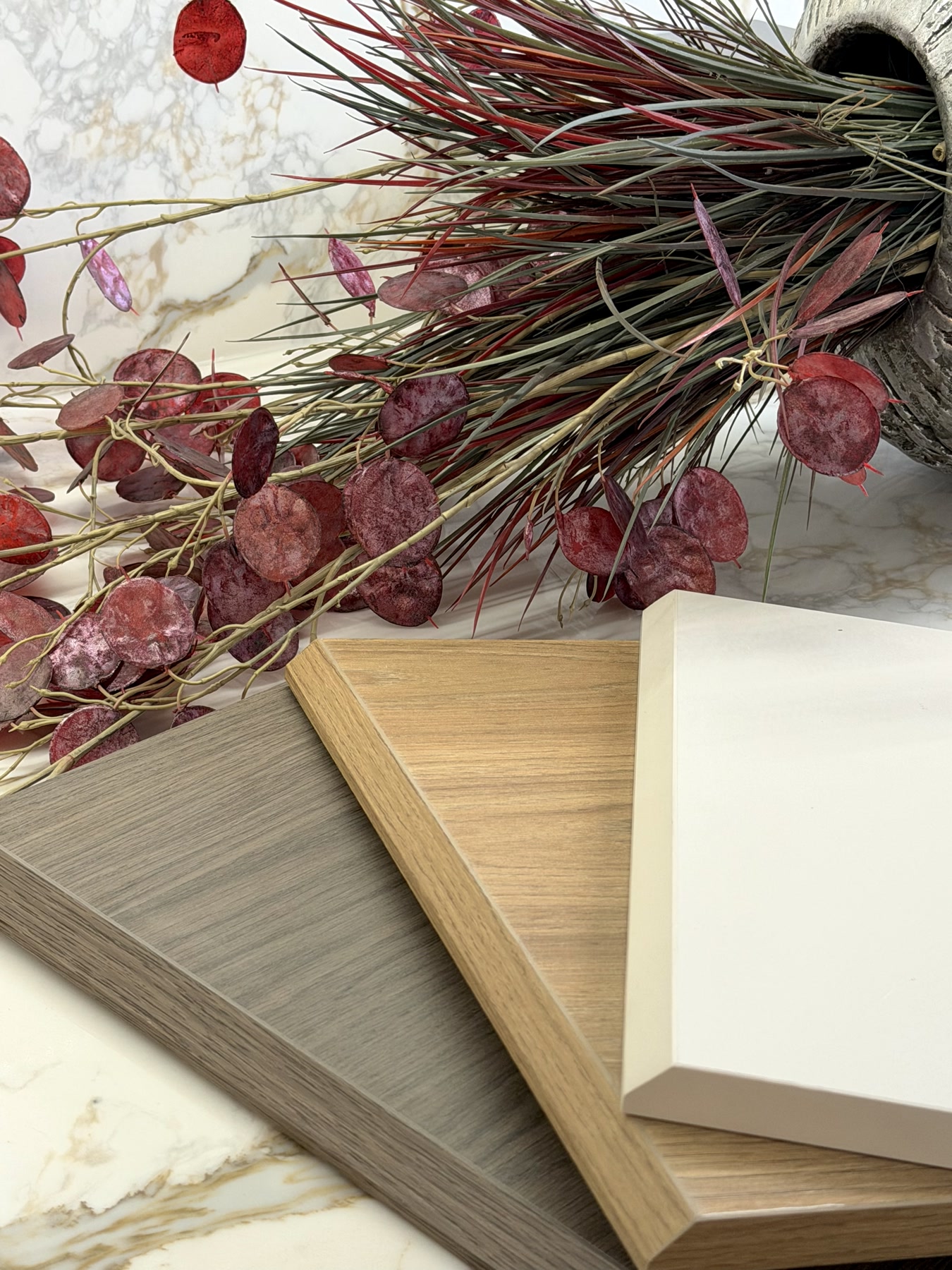 Cut and edge material samples in timber, white and grey finishes
